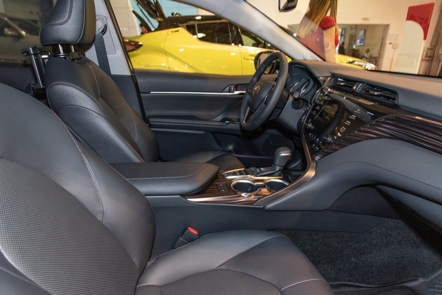 Interior view showing black leather seats and modern dashboard with center console.