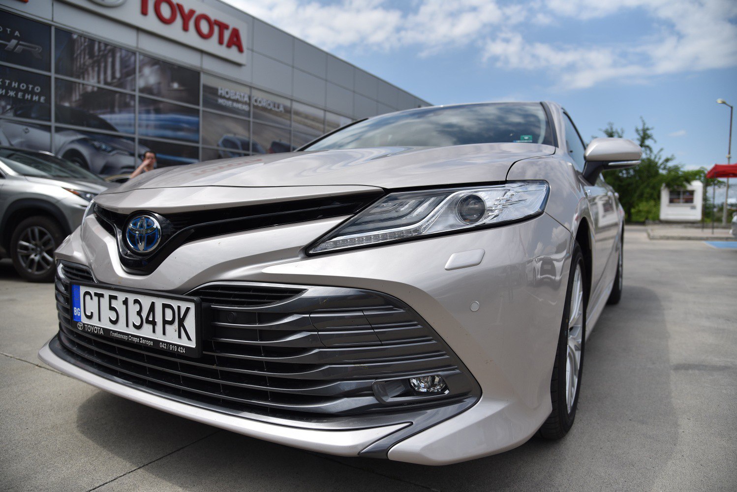 Close-up of sleek front grille and headlight design in modern sedan.