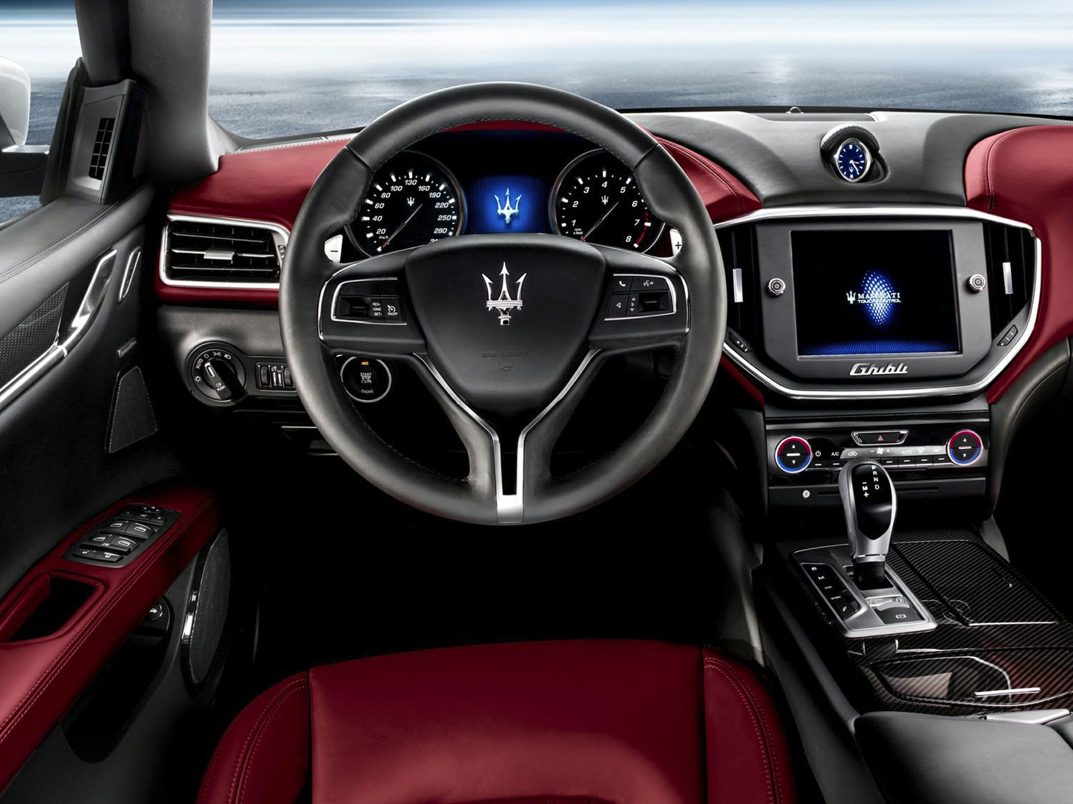 Luxury car interior cockpit with steering wheel, digital dashboard, and touchscreen infotainment system