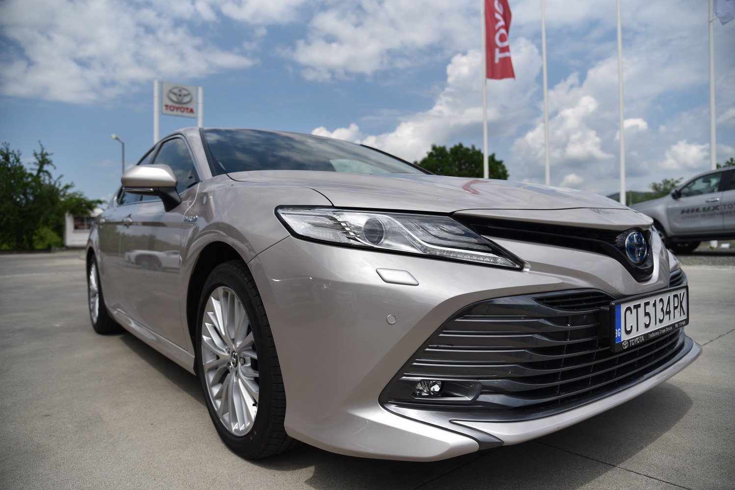 Close-up of car front showing LED headlights and wide grille