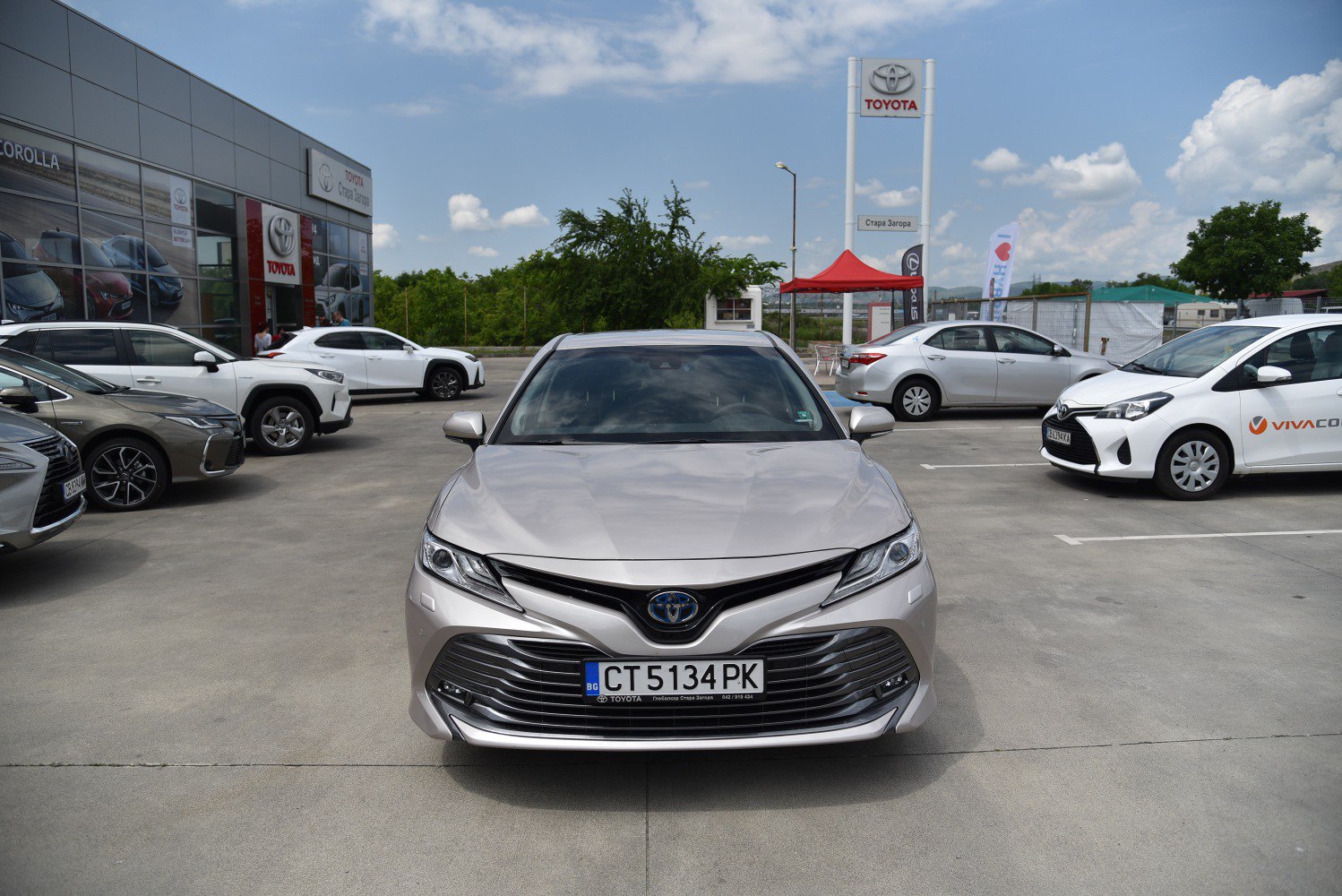 Modern sedan front with wide grille and sharp LED headlights