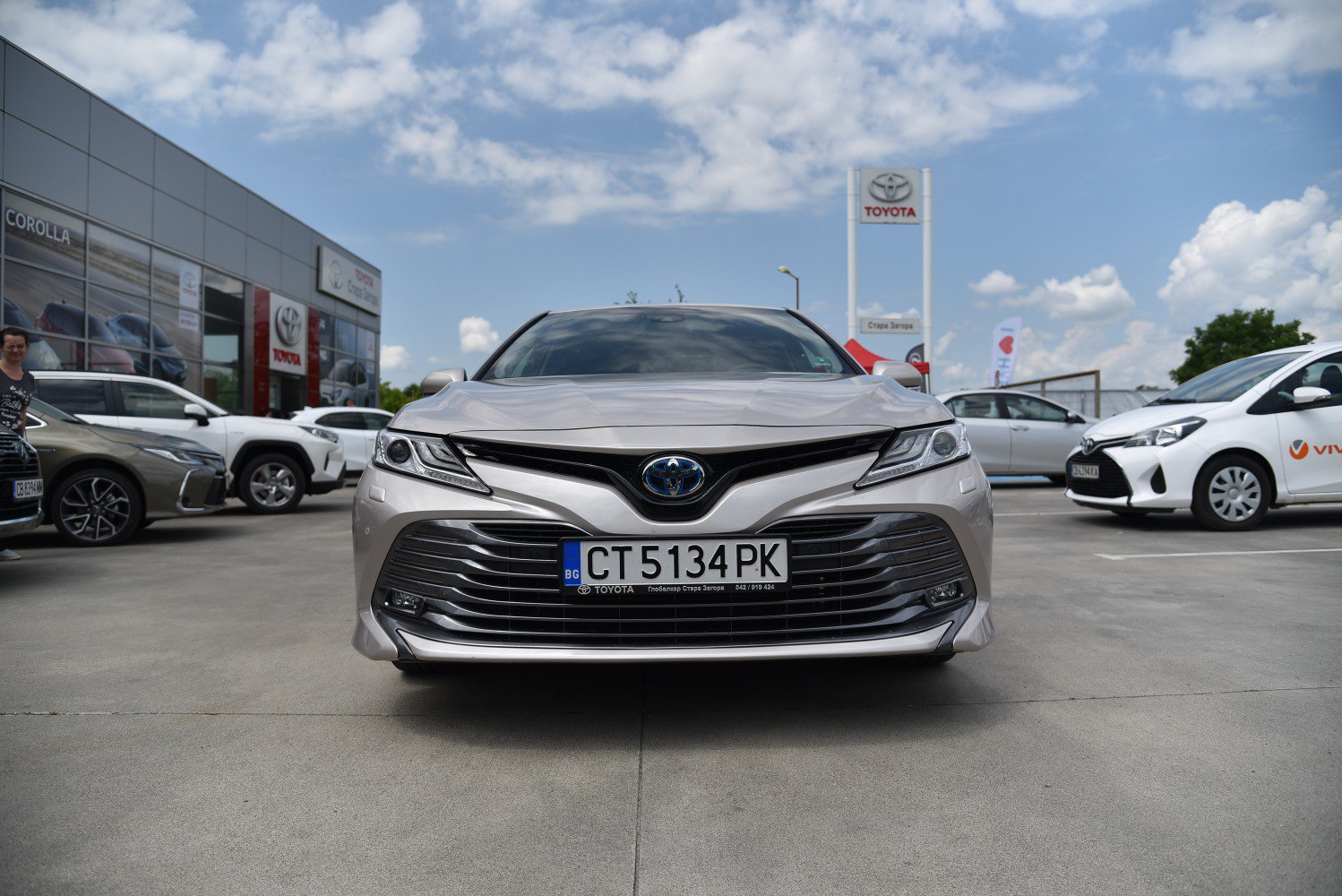 Front view with sleek headlights and wide grille design