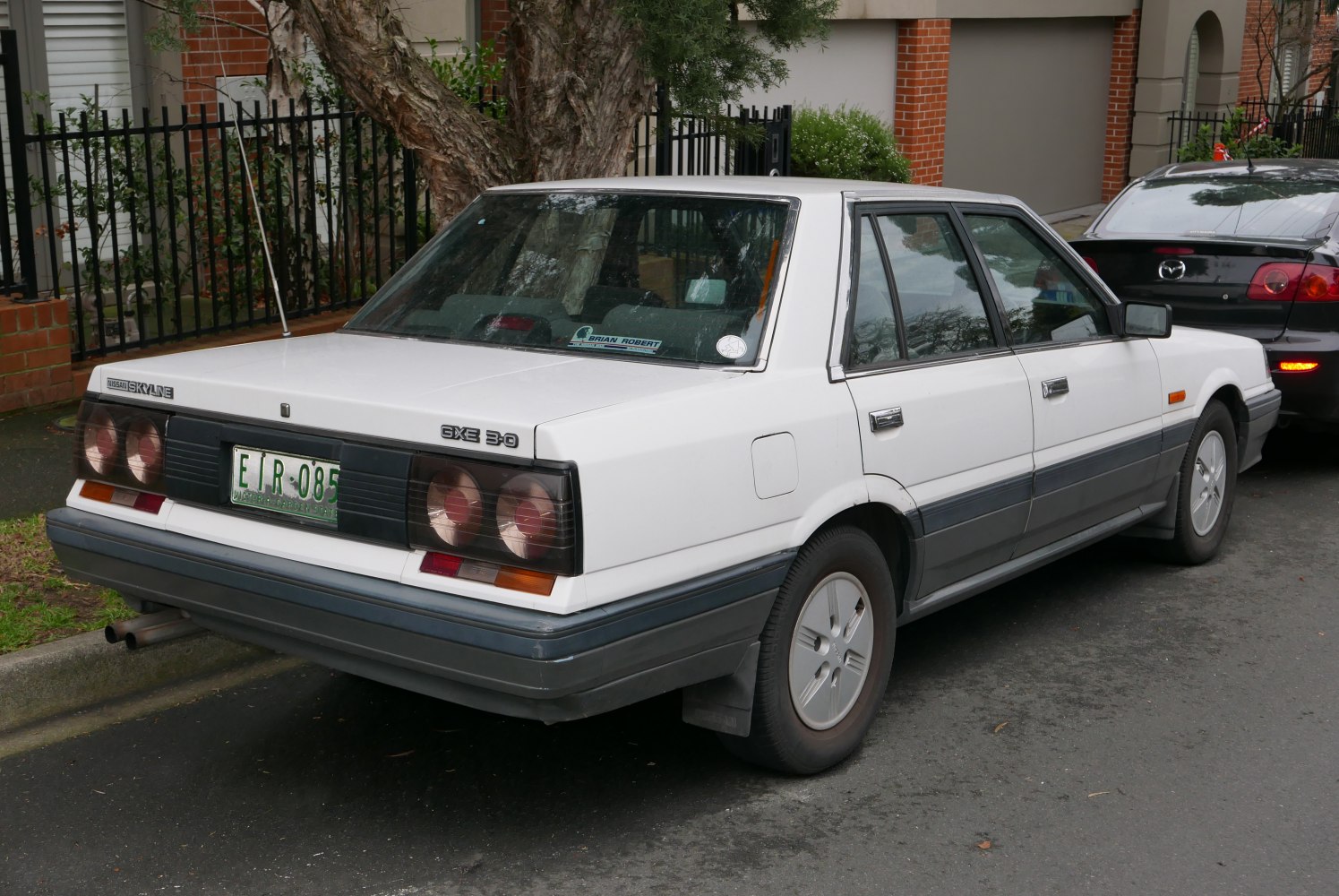 Rear and side view of classic sedan with distinctive taillights and boxy design