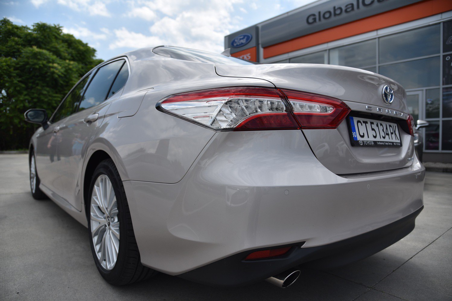 Rear view of a mid-size sedan highlighting tail lights and exhaust pipe