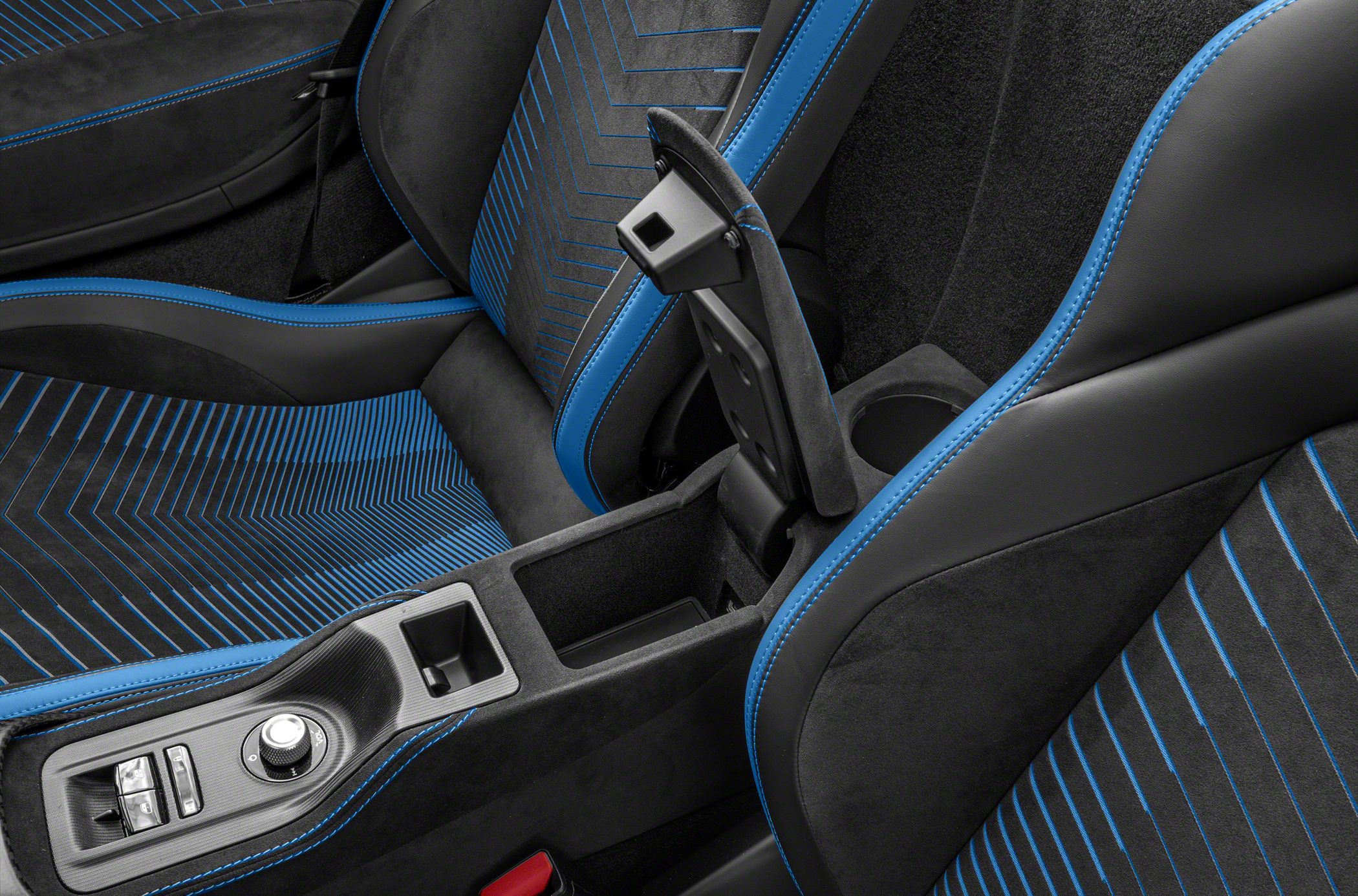 Car seats with blue accent stitching and center console with control dial.