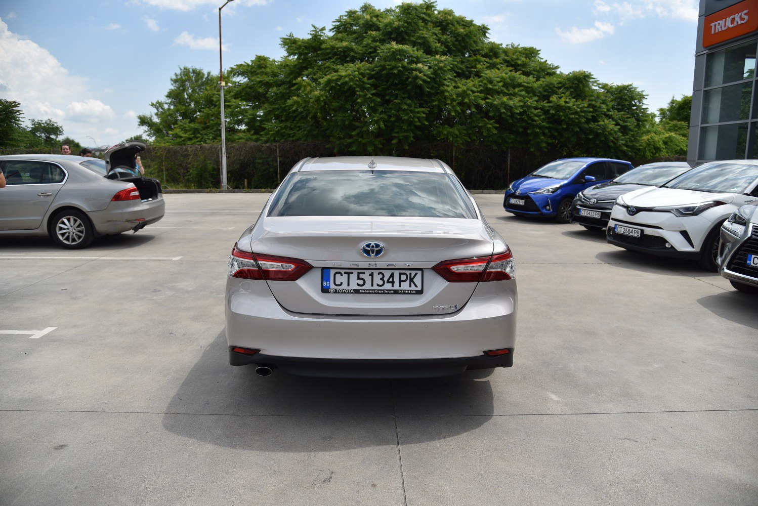 Rear view of a hybrid sedan with distinctive tail lights and single exhaust.