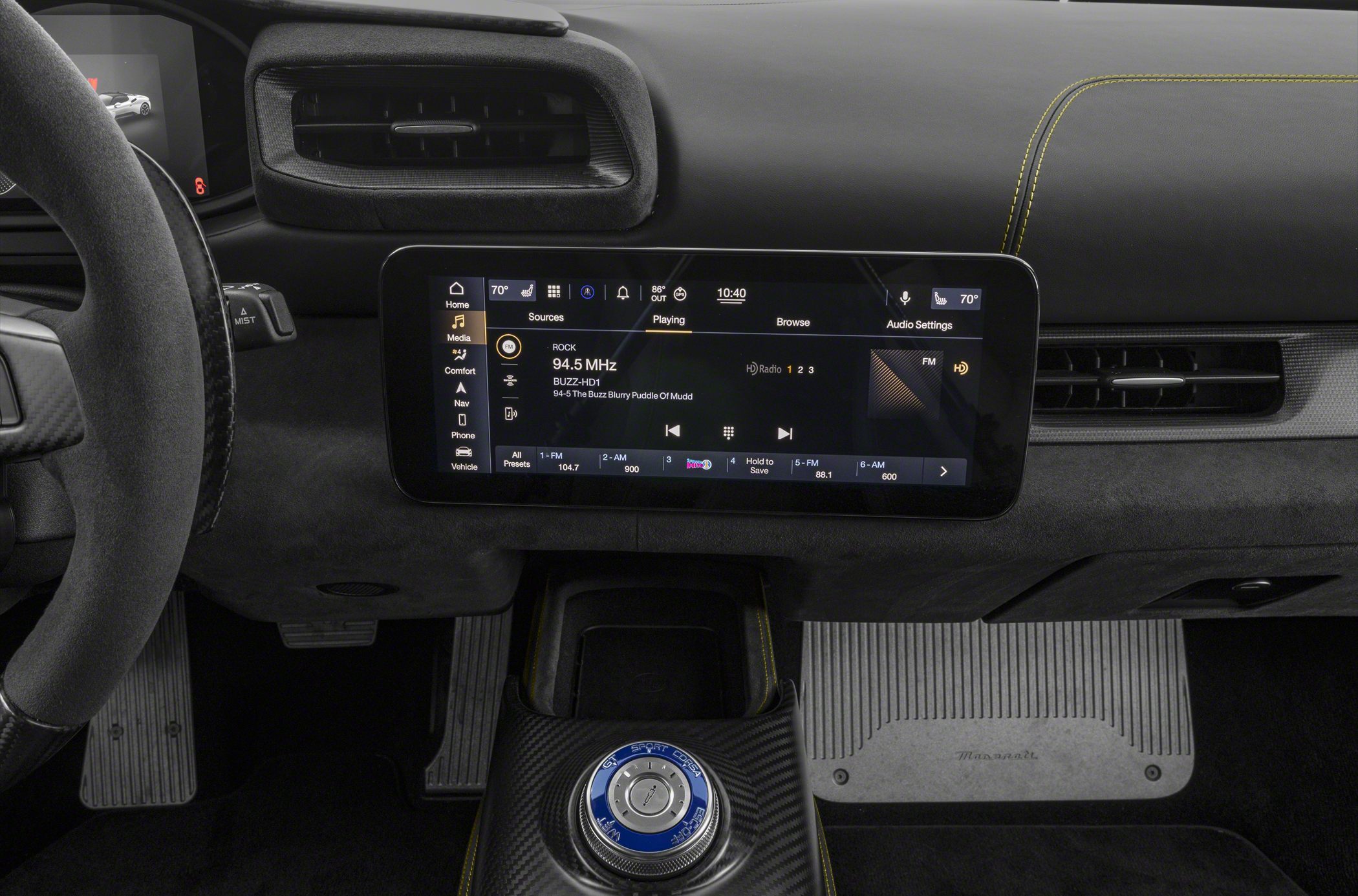 Digital infotainment display and rotary control knob in car interior