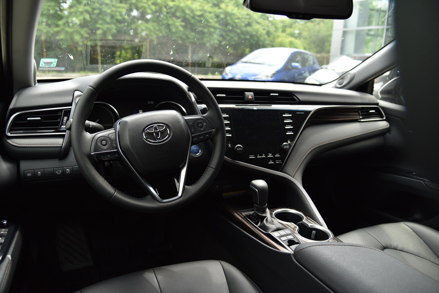 Car interior with steering wheel and dashboard infotainment system