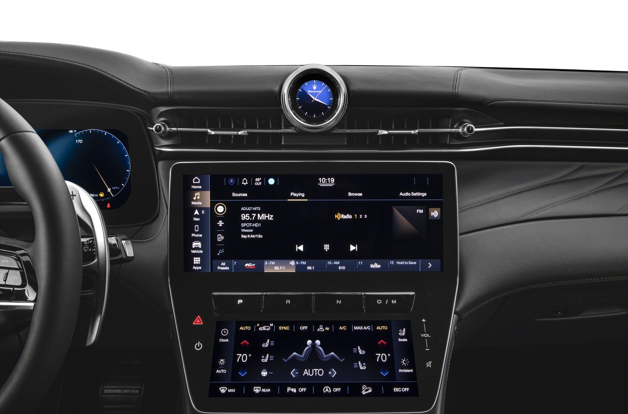 Dual touchscreen infotainment and climate control panels with analog clock in luxury car interior