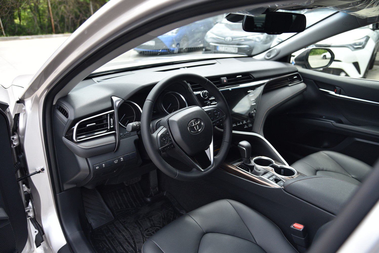 Modern car interior with steering wheel and dashboard details