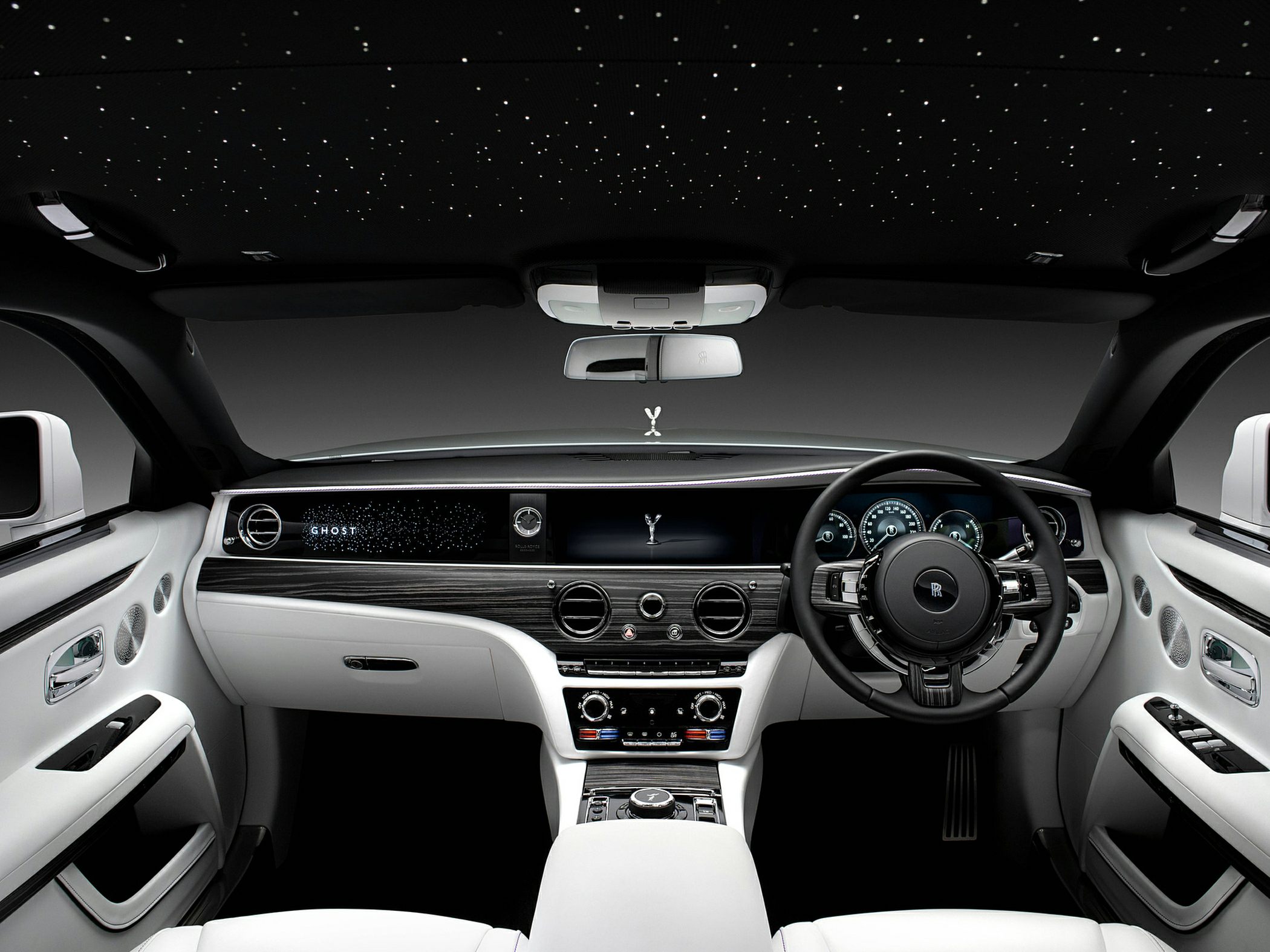 Luxury car interior with starry ceiling and digital dashboard