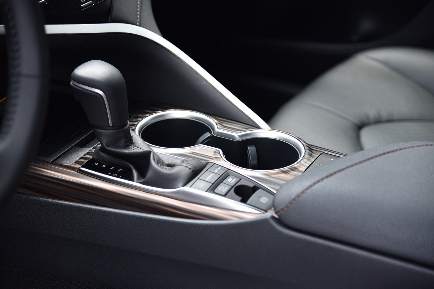 Close-up of gear shift lever and center console with cup holders