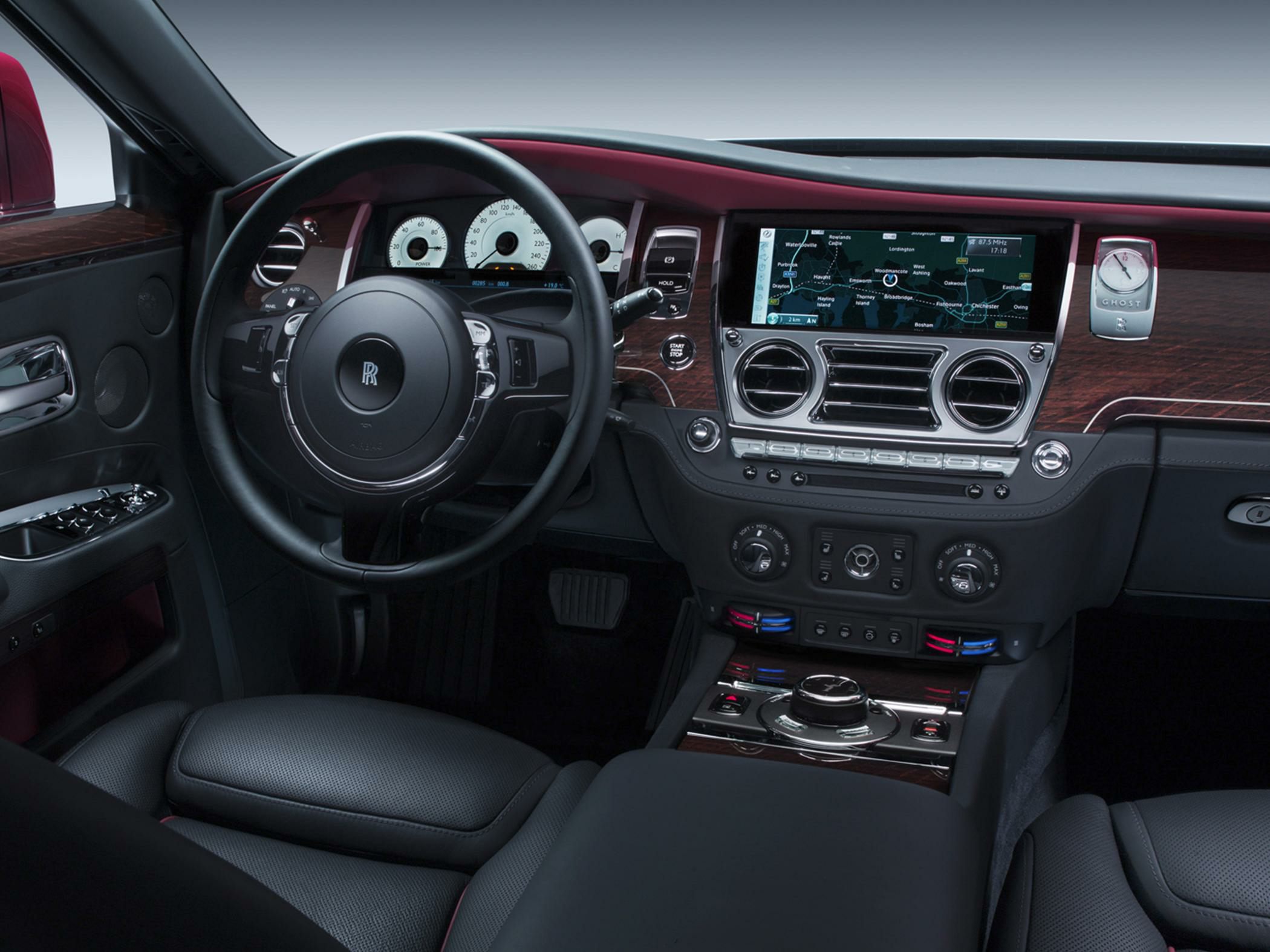 Luxury car interior with wood trim and digital navigation display