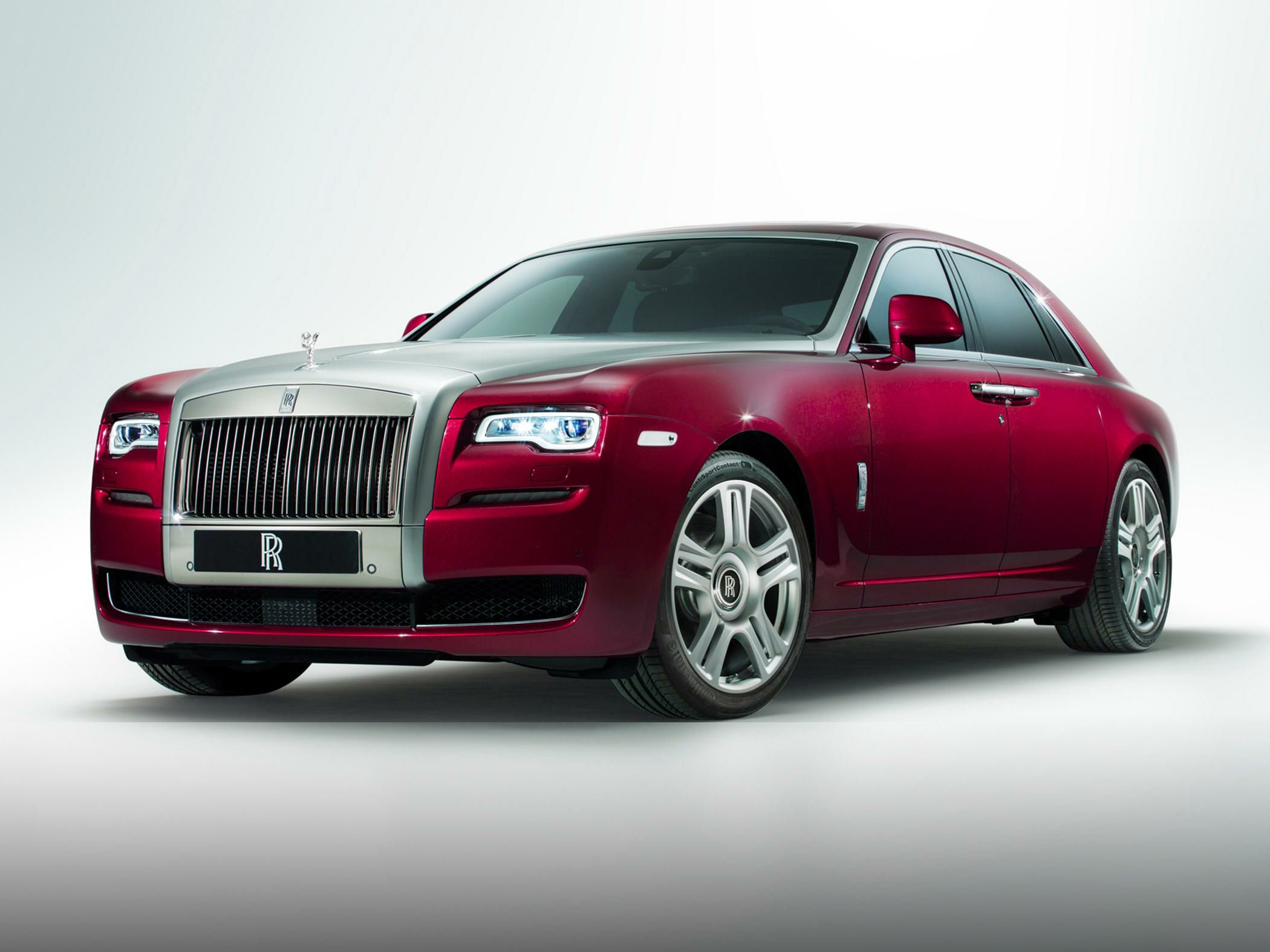 Front view of luxury sedan with LED headlights and large vertical grille