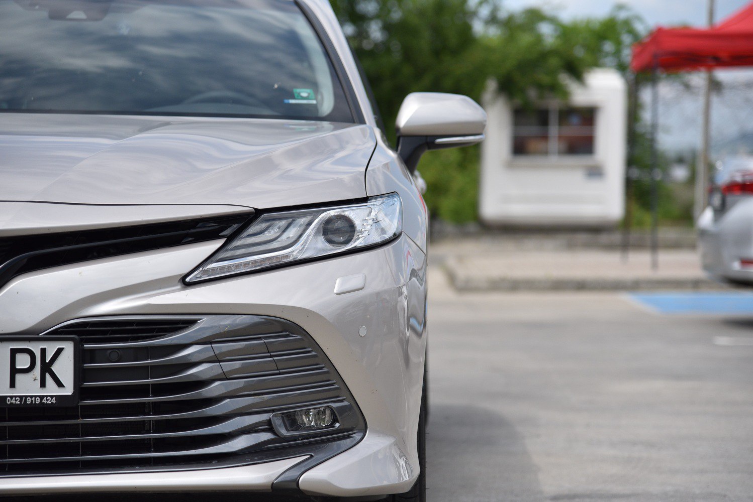 Close-up of front LED headlight and grille