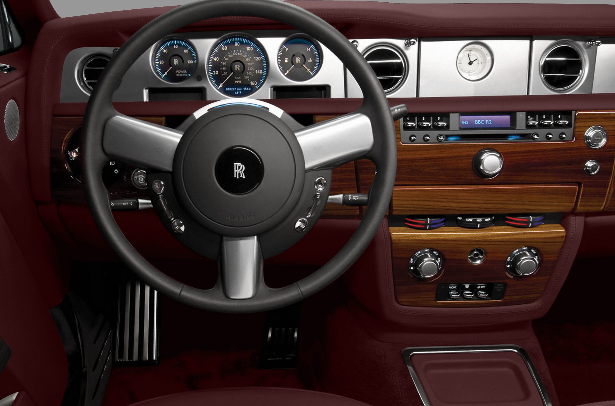 Luxury steering wheel and analog instrument cluster with wood dashboard trim