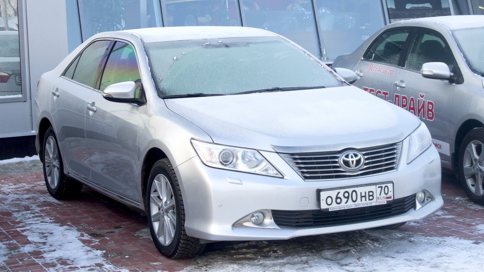 Silver sedan with modern headlights, alloy wheels, and frosted windshield
