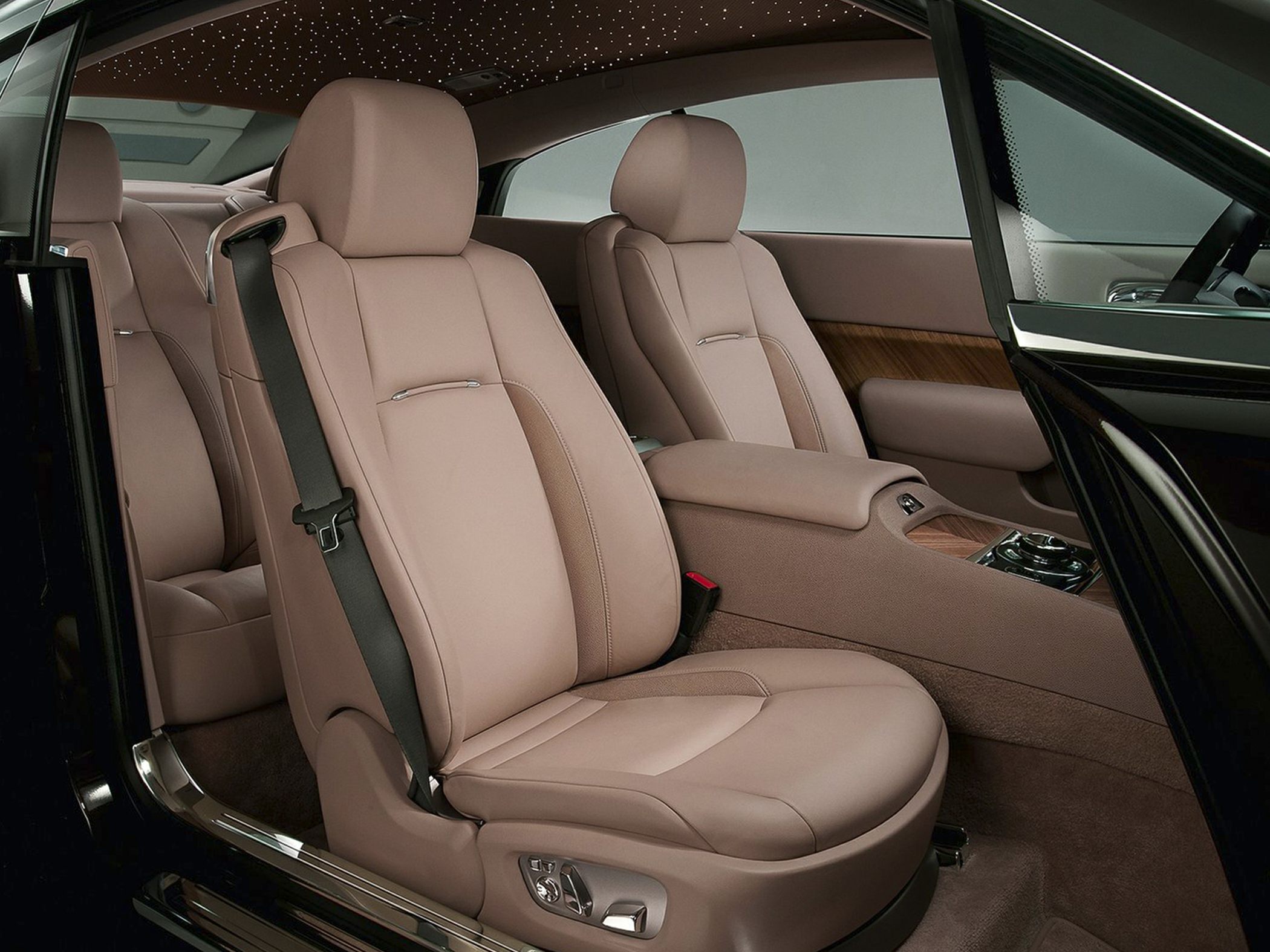 Beige leather seats and wood trim interior with detailed seat controls