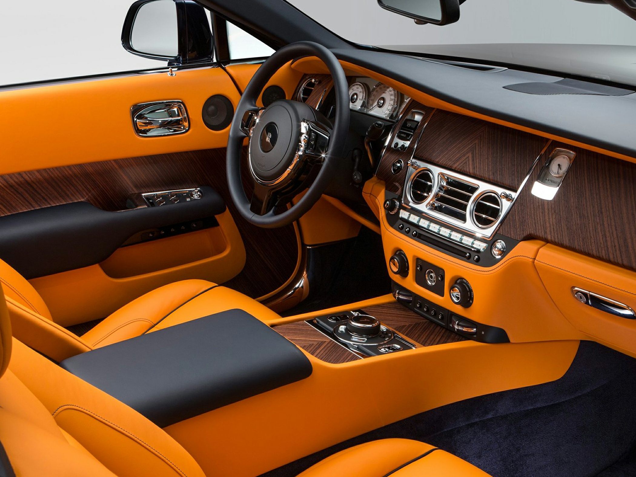 Luxury car interior with orange leather and wood paneling
