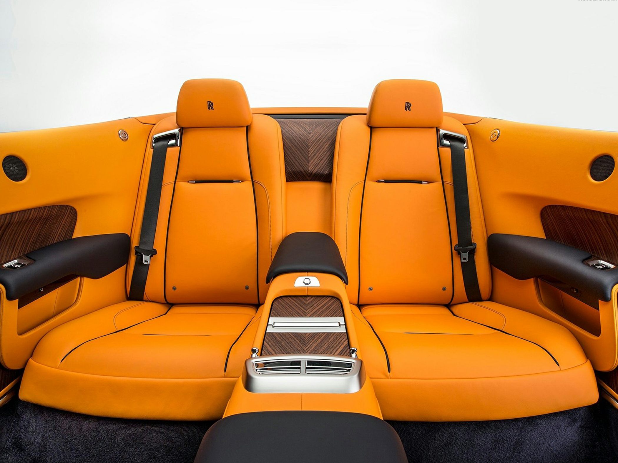 Rear seats with vibrant orange leather and wood trim