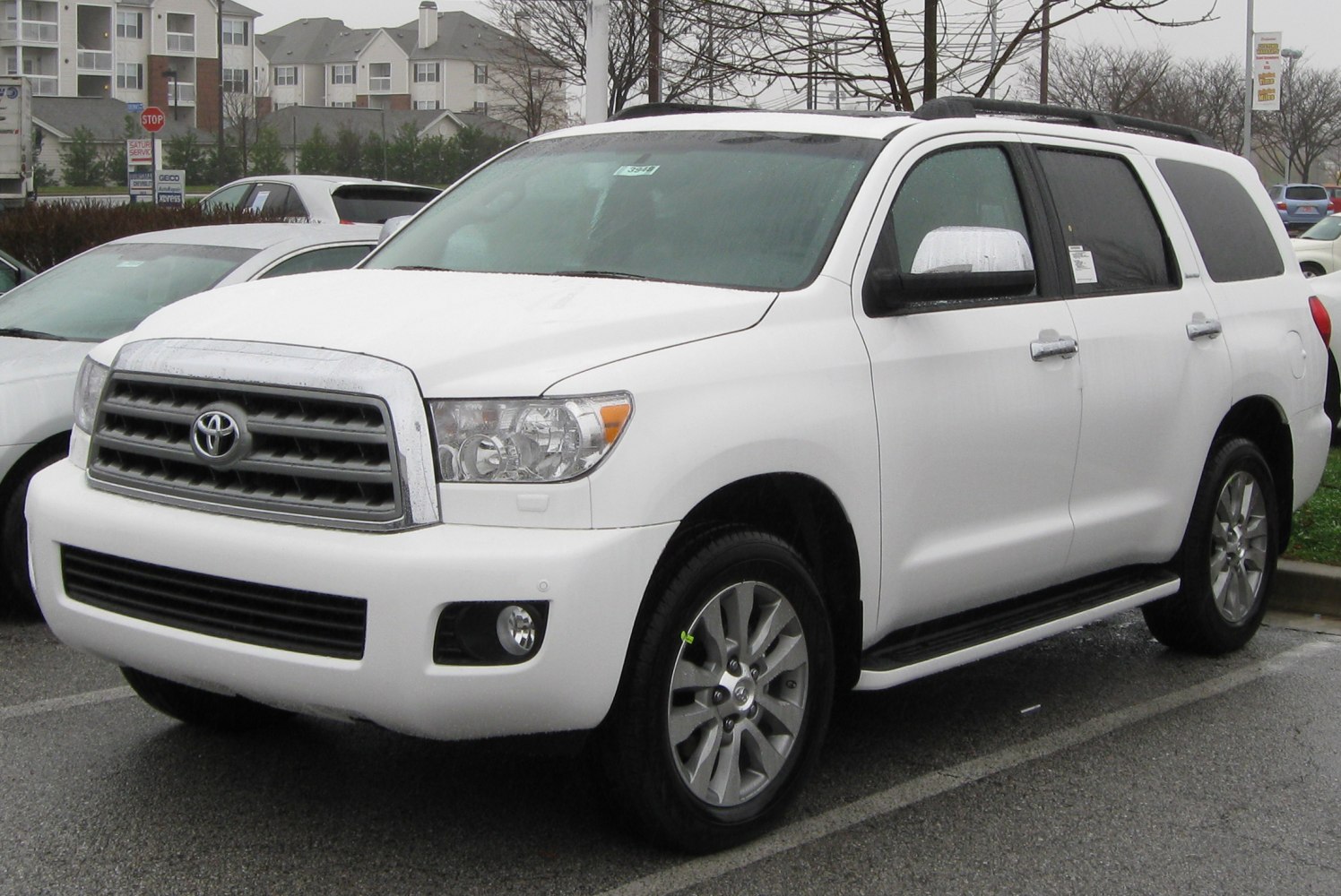 Large SUV front three-quarter view with chrome grille and roof rails