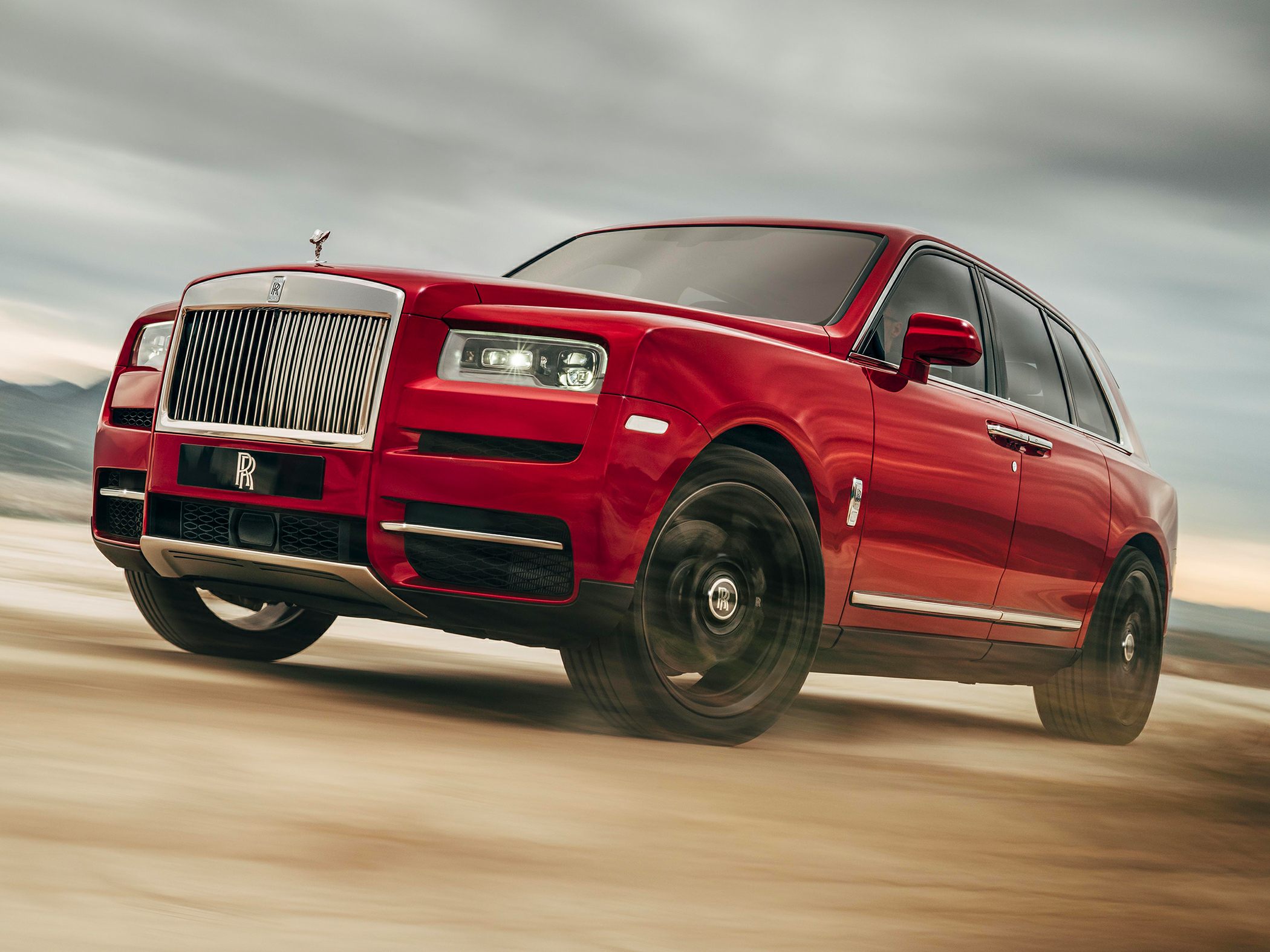 Luxury SUV with prominent front grille and LED headlights in dynamic motion