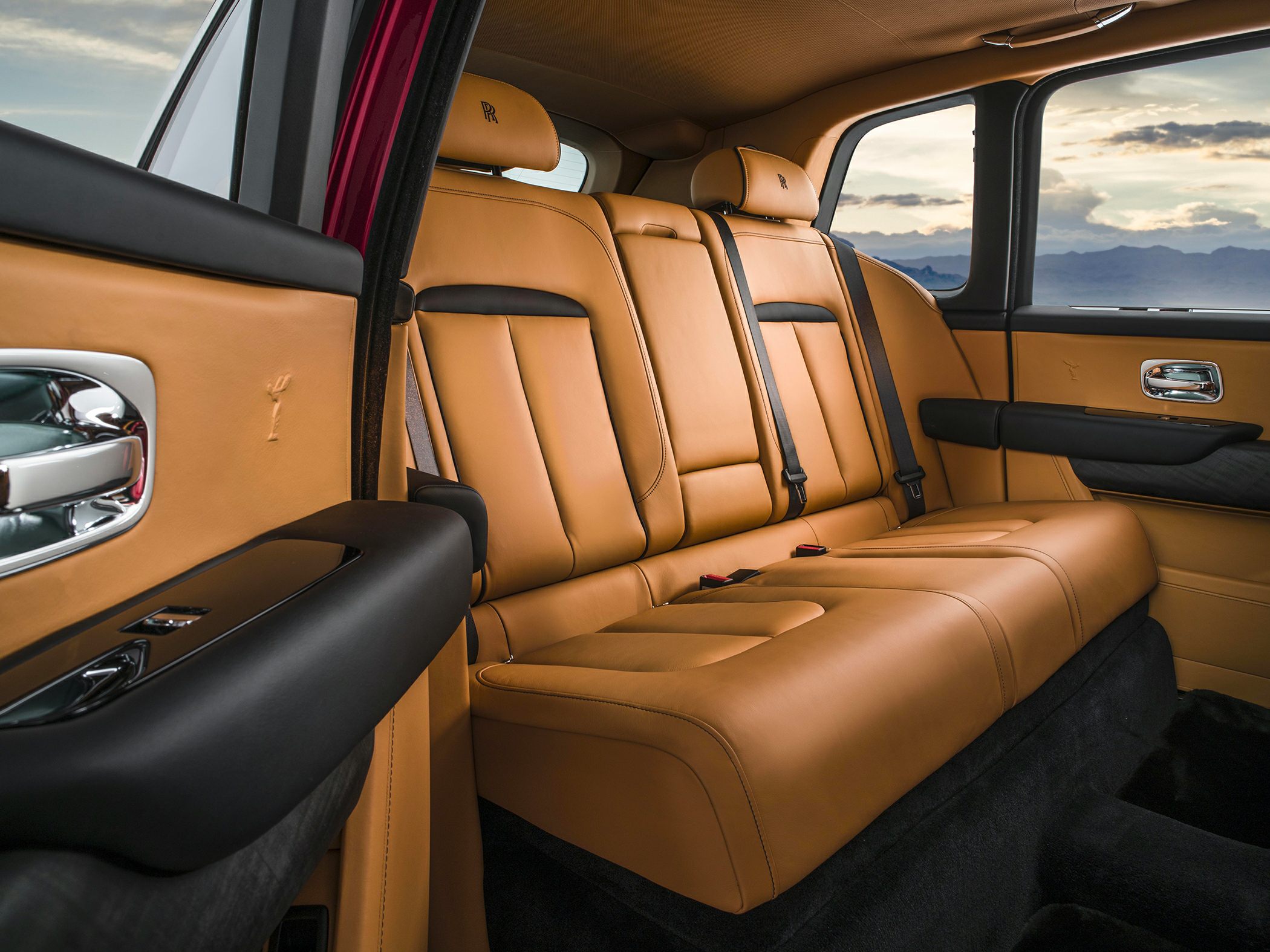 Tan leather rear seats with black accents and premium design