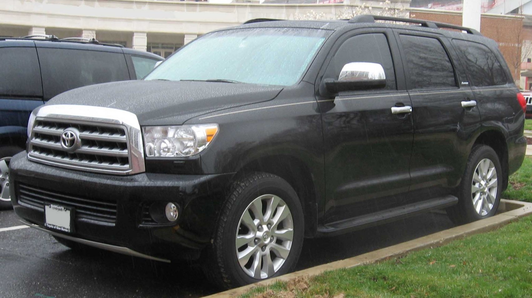 Black SUV with chrome grille, alloy wheels, and roof rails.