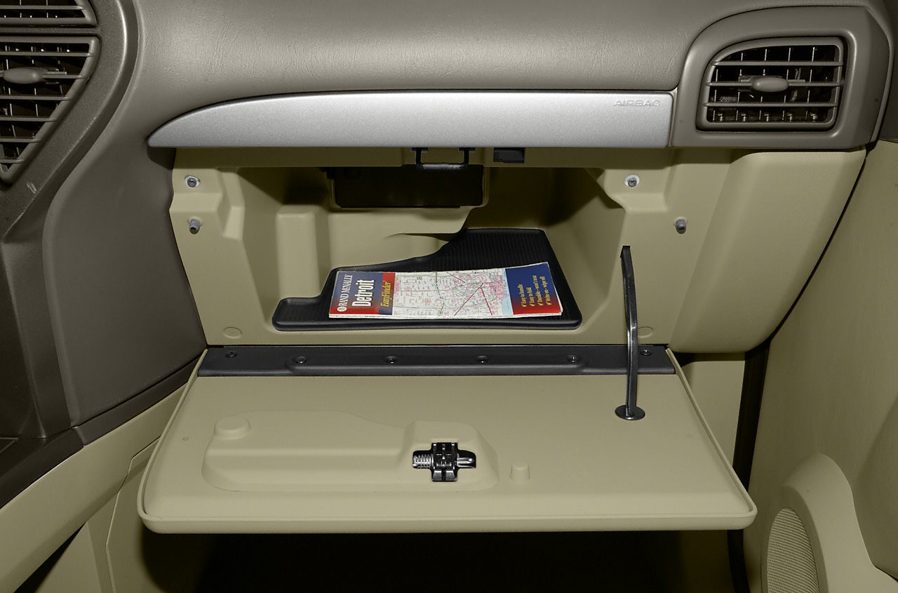 Open beige glove compartment with map holder and dashboard vents