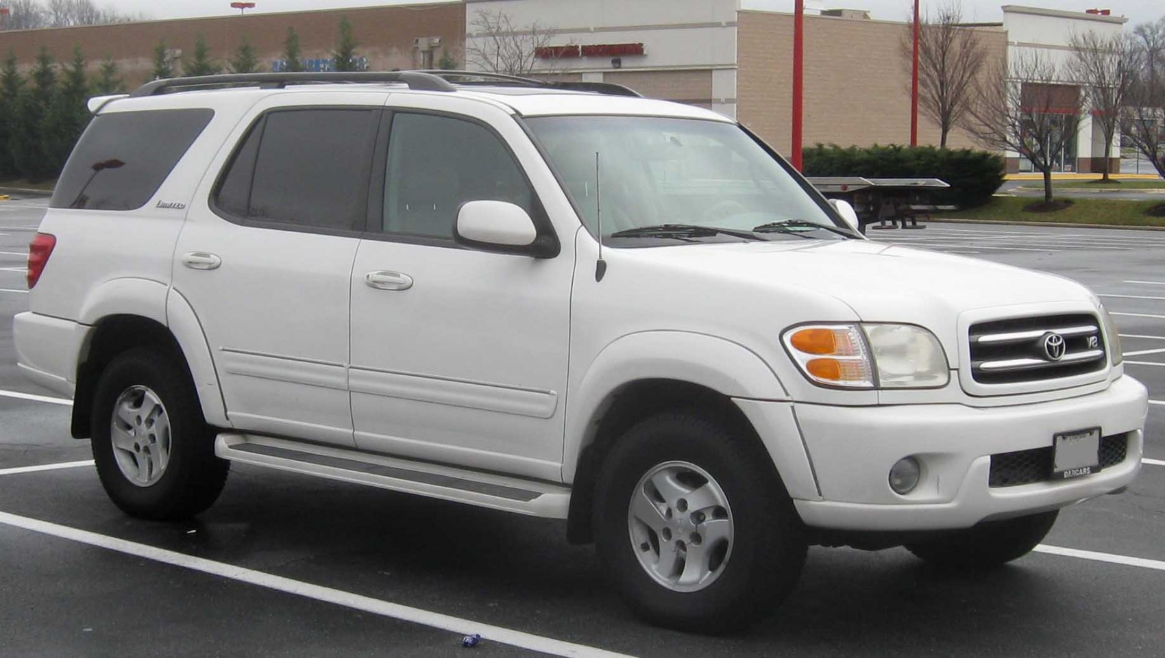 White SUV side profile with roof rails and off-road tires