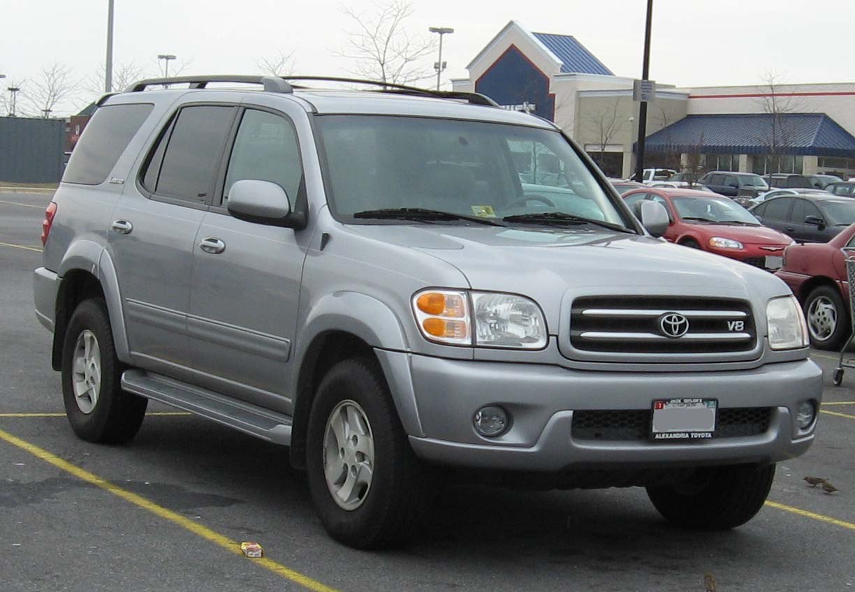 Silver full-size SUV with roof rails and V8 badge.