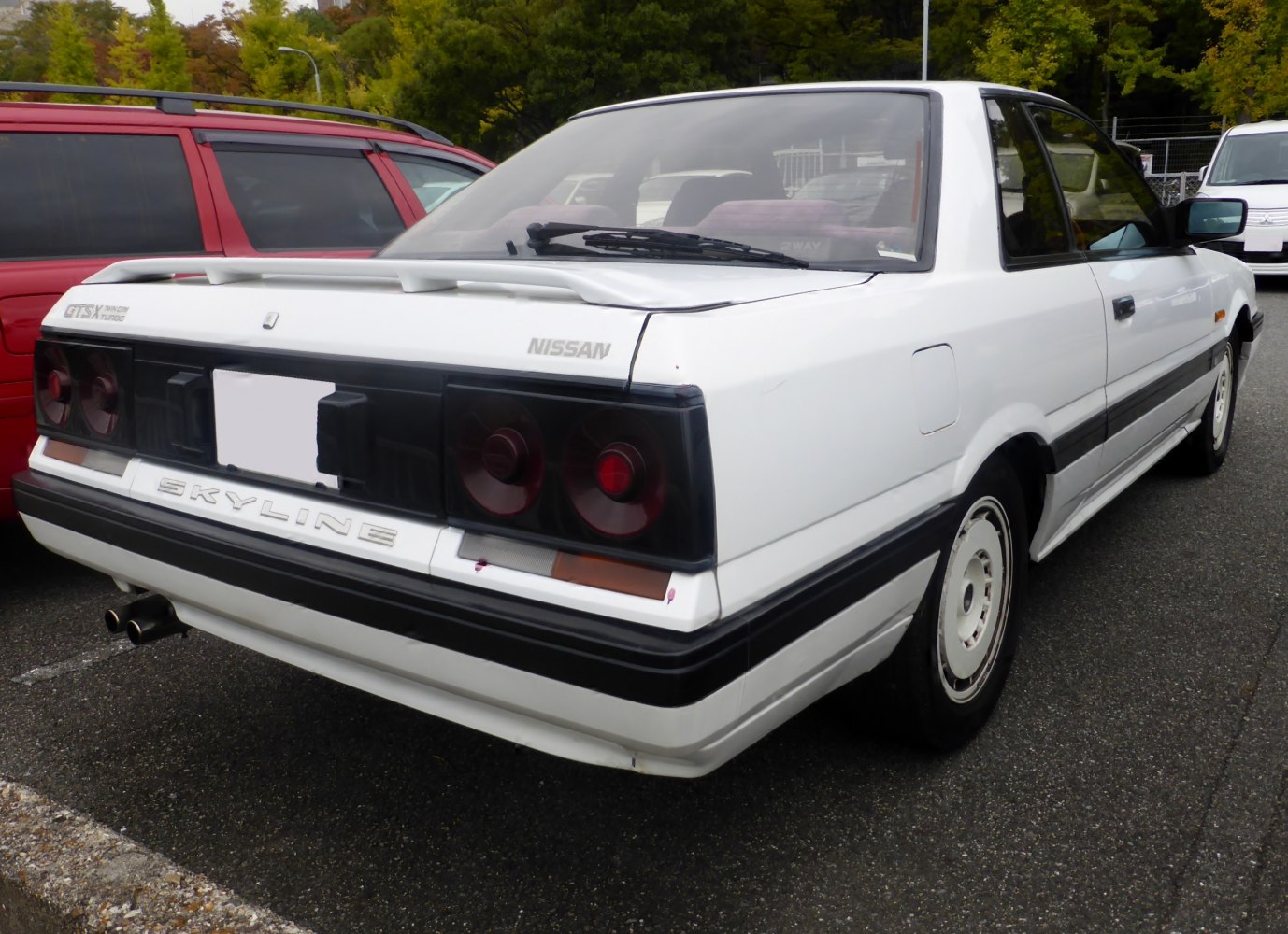 Rear view with distinctive taillights and rear spoiler of vintage coupe