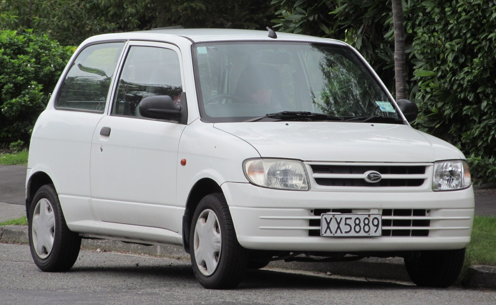 Compact hatchback front view with distinctive headlights and grille