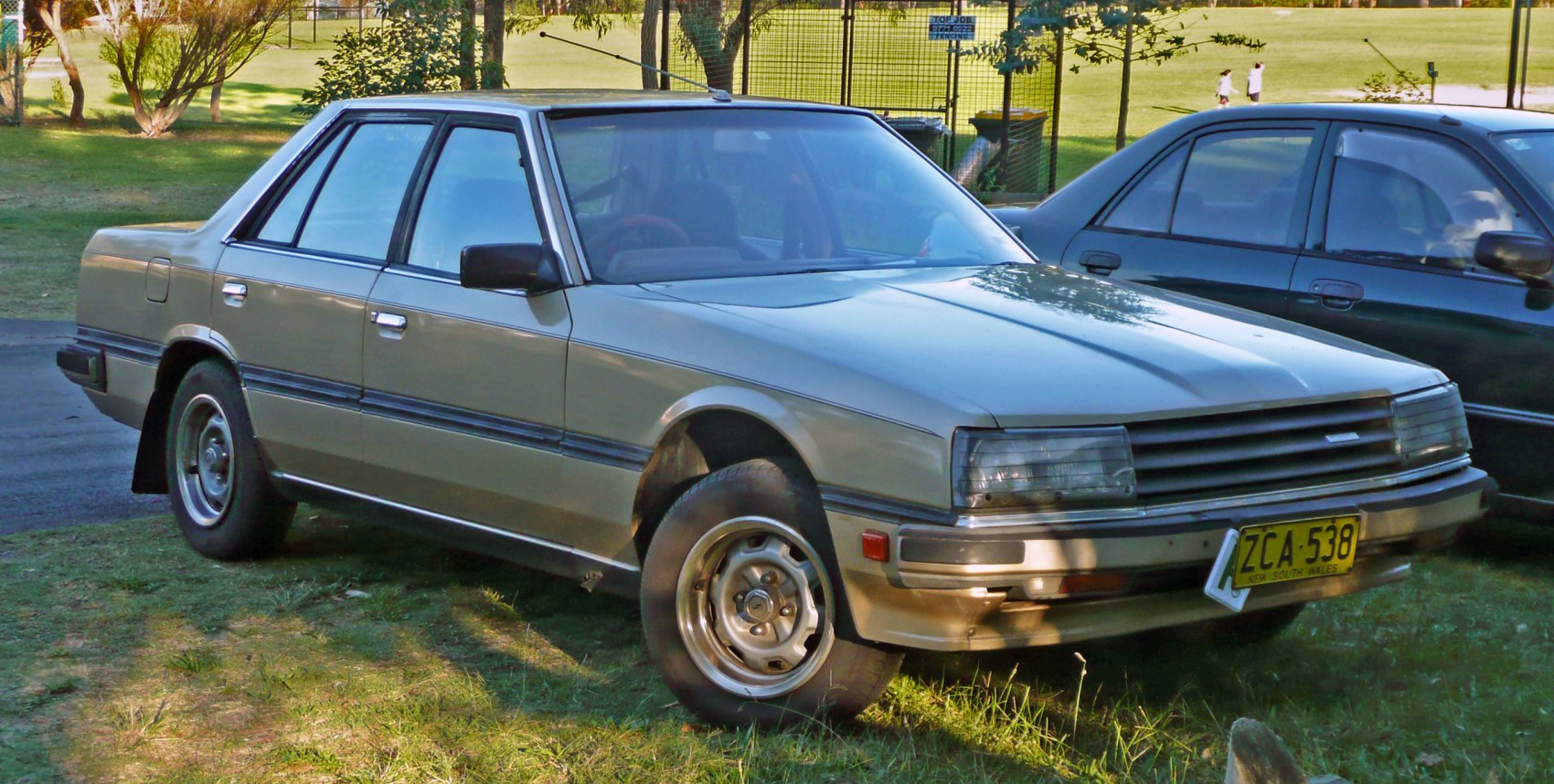 1980s boxy sedan with rectangular headlights and steel wheels