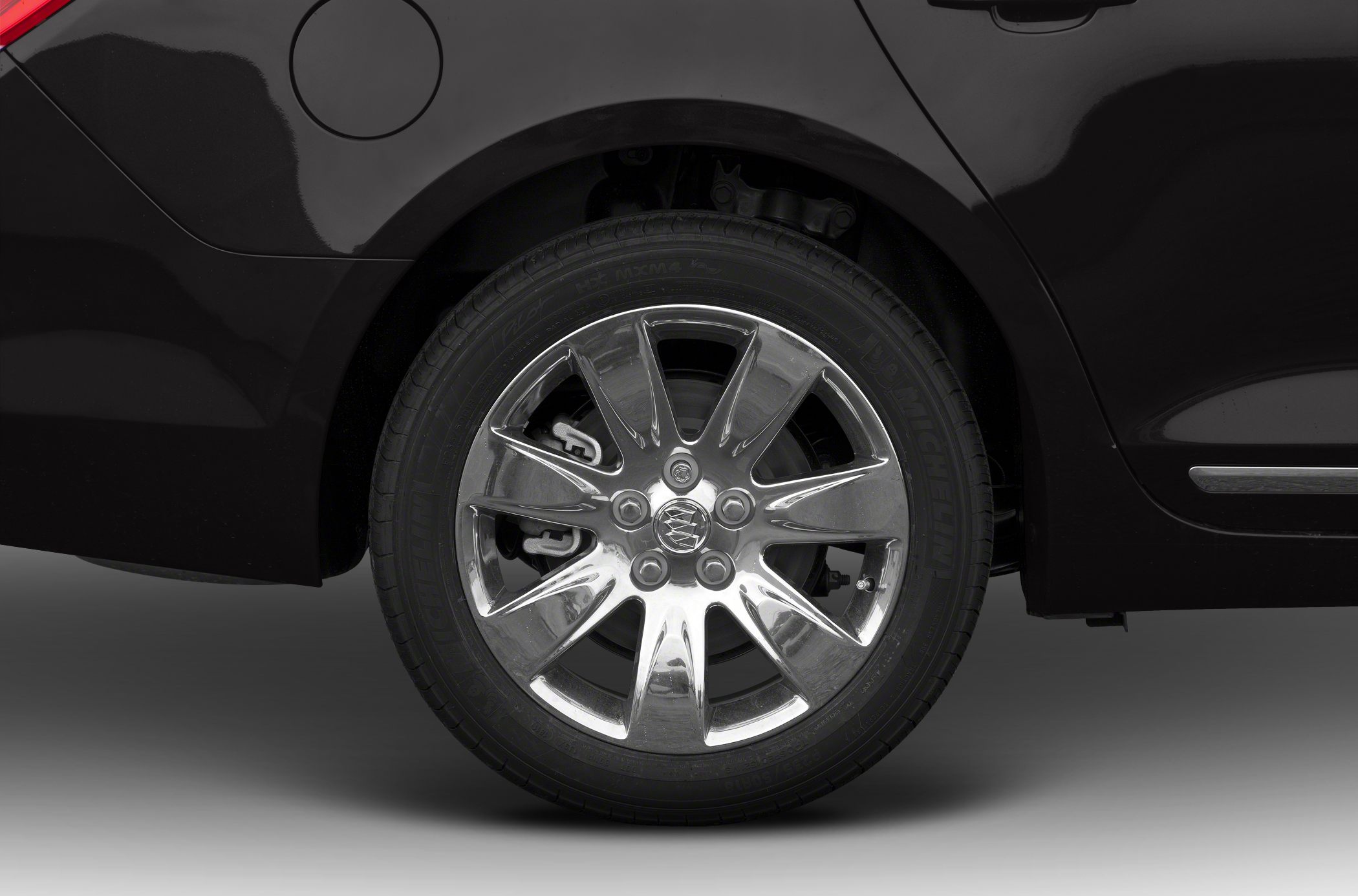 Chrome alloy wheel and tire on passenger rear side