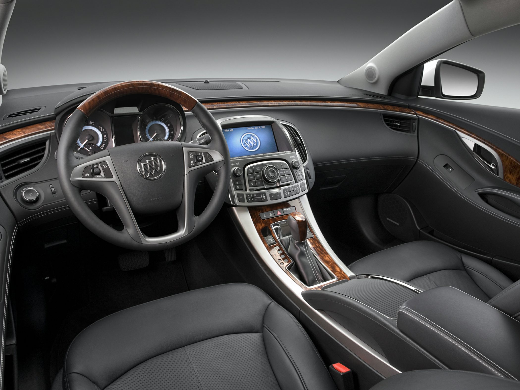 Wood-trimmed steering wheel and detailed central console with controls