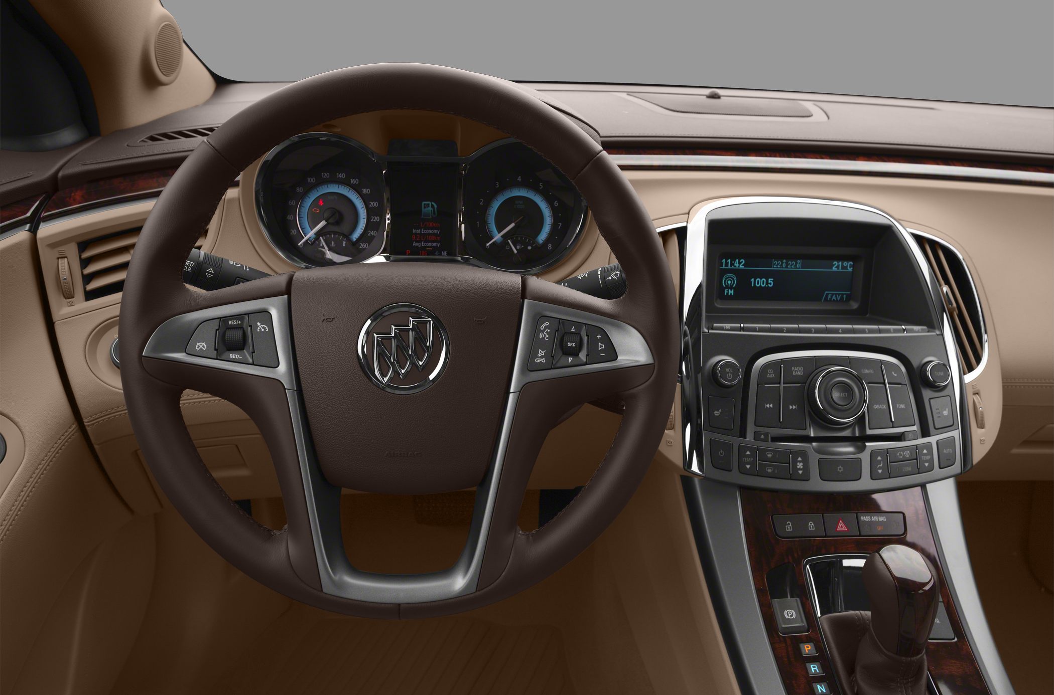 Steering wheel with controls and dashboard featuring instrument cluster and center console.