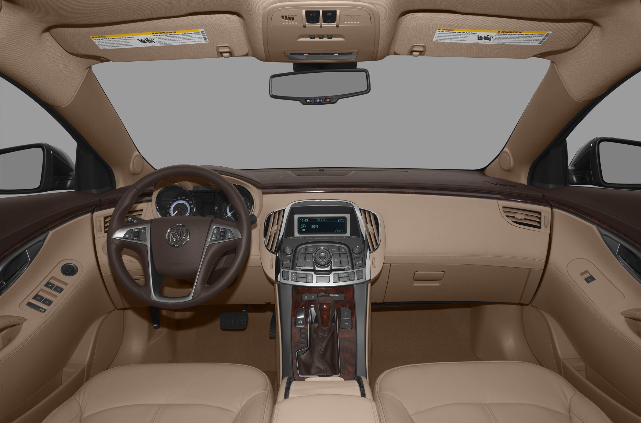 Luxury car interior dashboard and steering wheel with wood trim and infotainment display