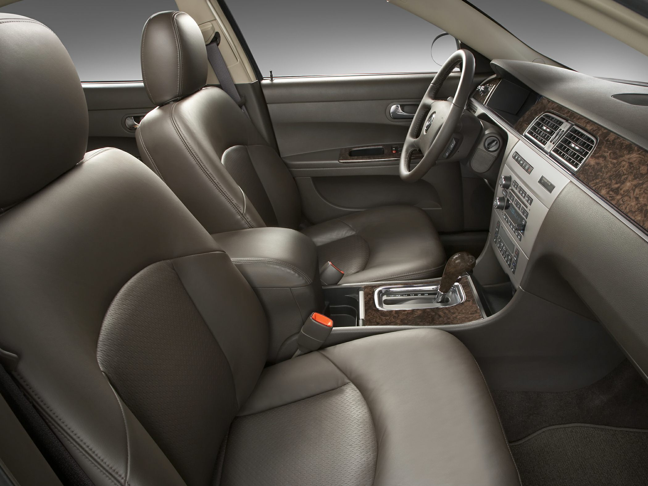 Leather seats and wood grain dashboard with automatic gear shifter.
