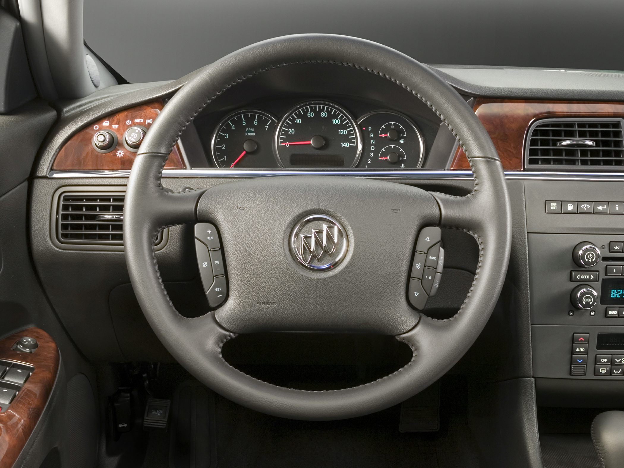 Steering wheel, instrument cluster, and dashboard with wood trim
