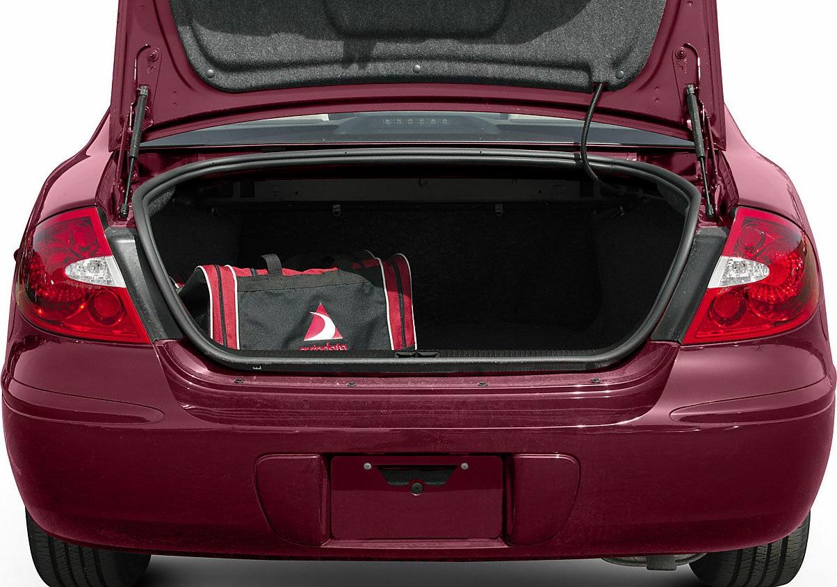 Open car trunk with a travel bag inside