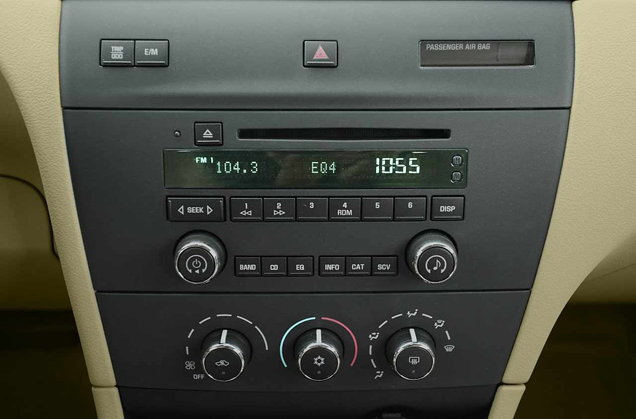 Car radio display and climate control knobs on dashboard.