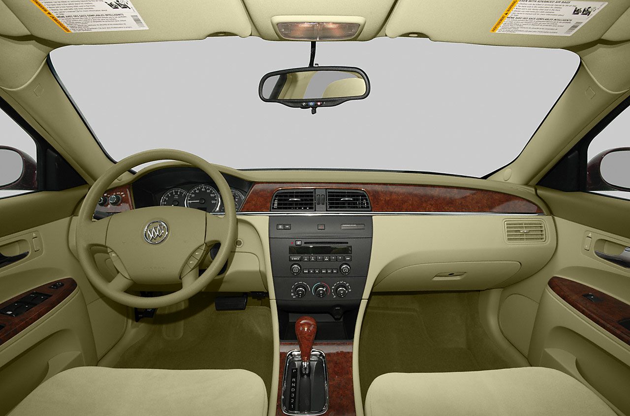 Dashboard, steering wheel, center console with wood trim in beige interior