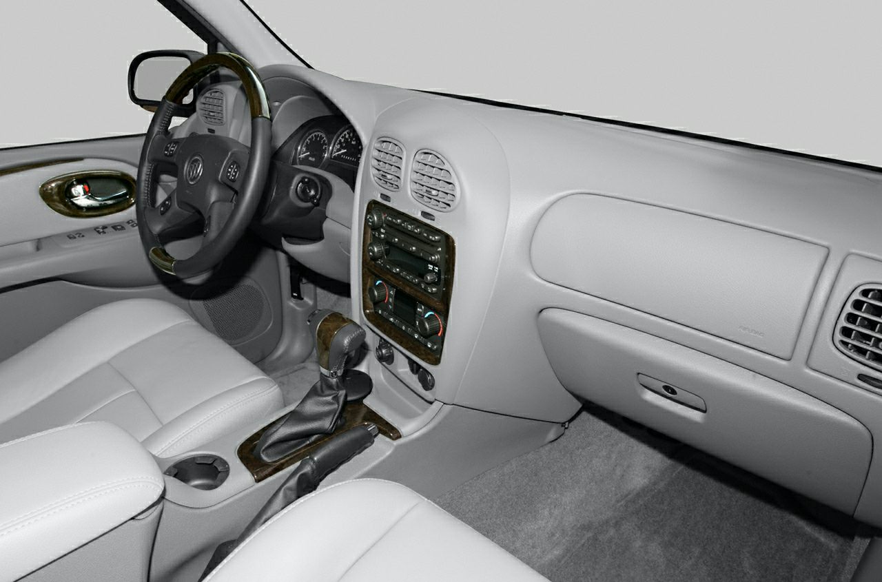 Dashboard, steering wheel, and center console with wood trim and controls