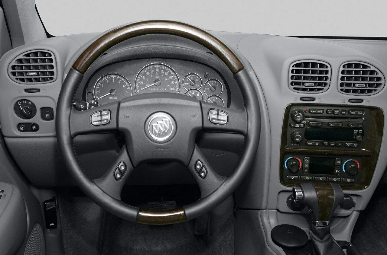Dashboard with wood-trimmed steering wheel and instrument cluster