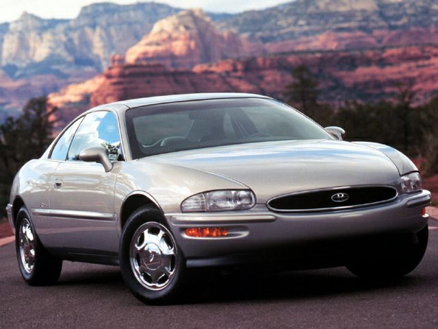 Front view of a luxury coupe with sleek headlights and chrome wheels