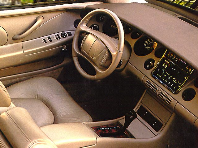 Classic car interior with steering wheel, dashboard, and ergonomic seat.