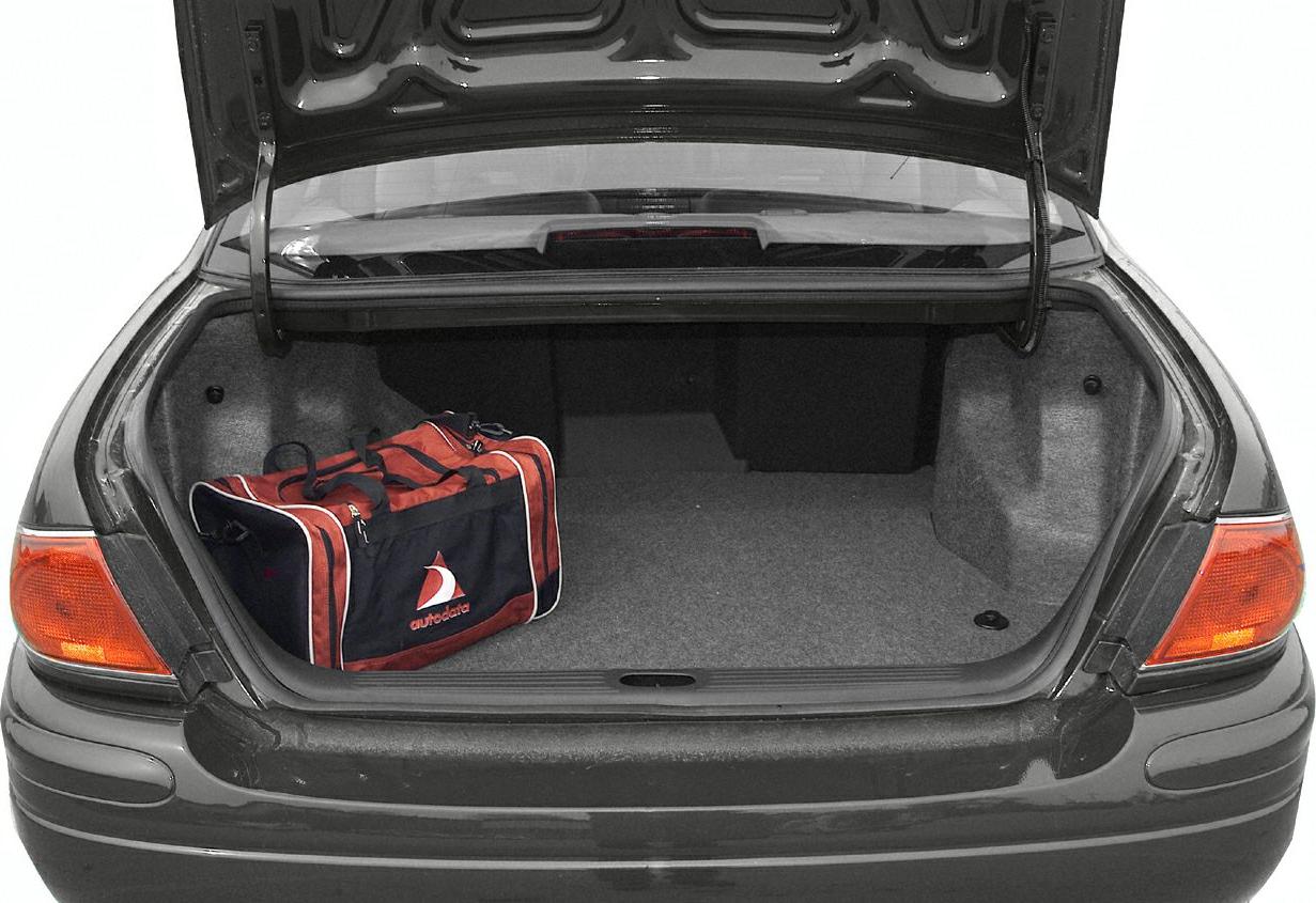 Spacious open trunk with dark interior and a red-black duffle bag.