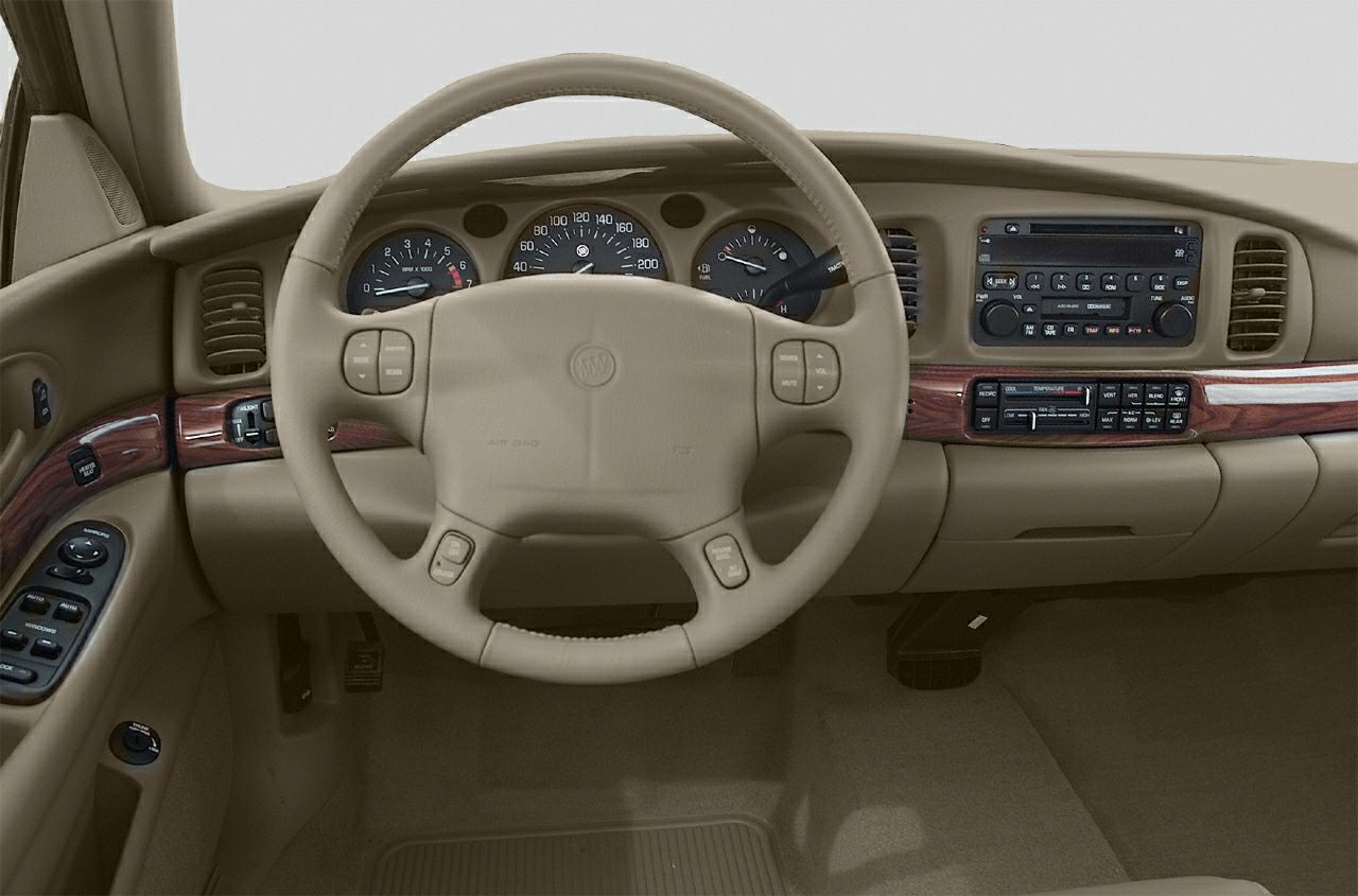 Beige dashboard and steering wheel with wood trim and analog gauges