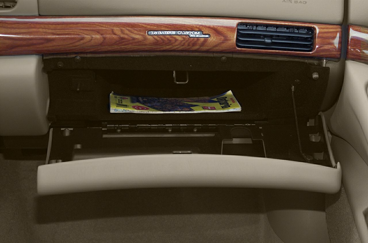 Open glove compartment with wood trim and air vent